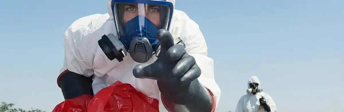 sewage clean up technician wearing protective gear handling biohazard materials in Dallas, TX