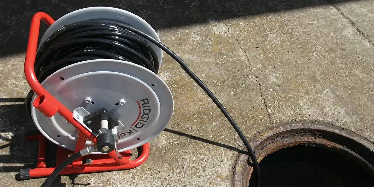 sewer rodding equipment prepared to clear clogged sewer lines in Dallas, TX